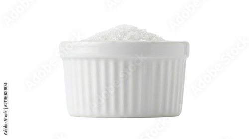 Fotografie White ceramic bowl filled with granulated sugar on white background