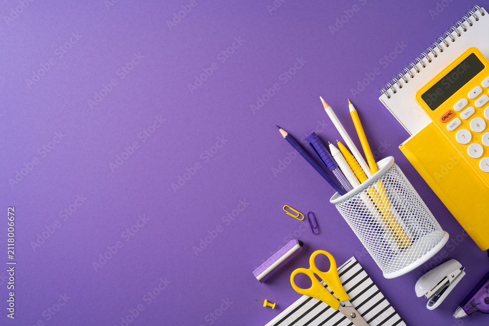 Obraz premium Back to school supplies on purple desk with organized stationery, calculator and pencil holder