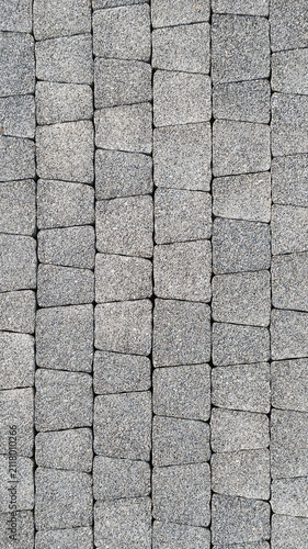 The pavement is made of gray cobblestones with intertwining stone blocks. The natural exterior is ideal for architectural, landscape, building and urban design