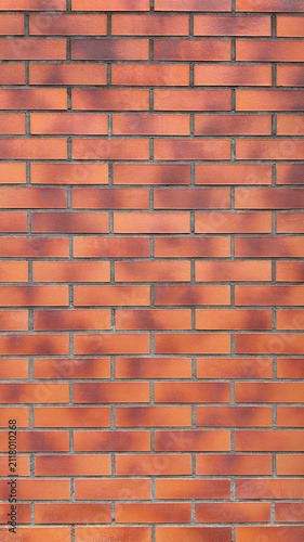 Classic red brick wall with horizontal masonry pattern. Clean architectural background featuring traditional brickwork