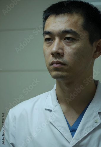 Serious asian male doctor o...