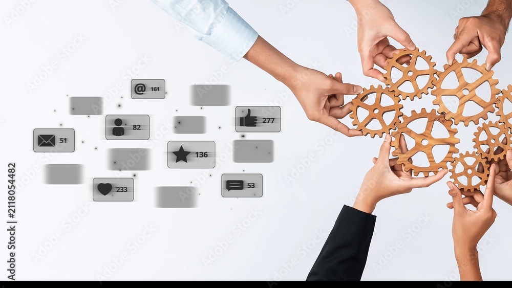 Obraz premium Diverse hands work together with wooden gears, symbolizing collaboration and interaction, alongside digital icons showcasing social media notifications and engagement. Raster