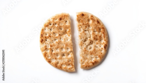 Broken machine-made matza flatbread, isolated on a white background.