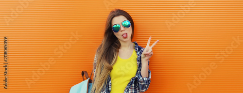 happy cheerful stylish young woman posing against background