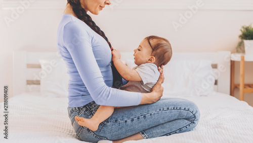 Photography Happy Mother With Baby Sitting Together On Bed, Engaging In Playful Interaction And Bonding At Home
