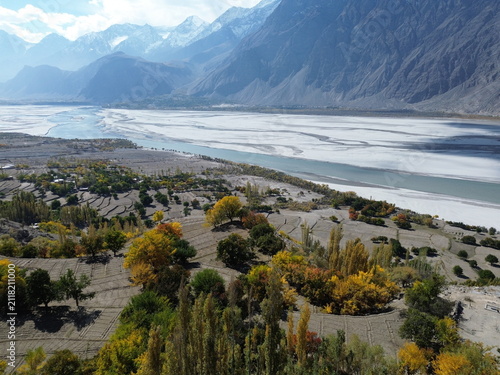 Photography Aerial view of river valley and terraced fields in mountains