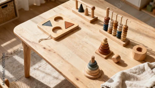 Educational Montessori wooden toys, shape sorters and stackers on a sunlit wooden table