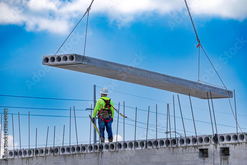 Принти на полотні Low angle view of a construction worker guiding a precast hollow core concrete s