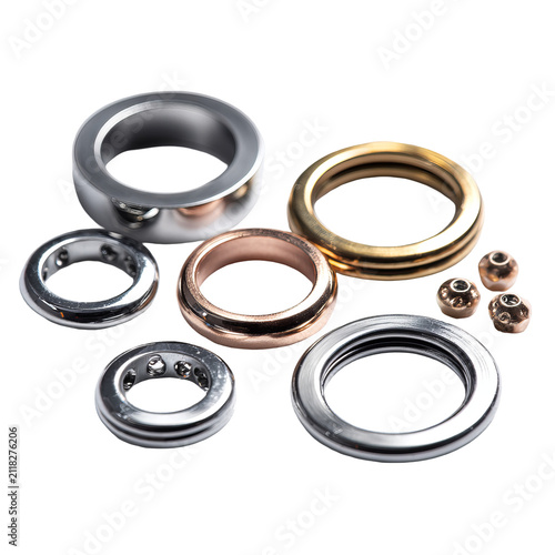 Metallic rings, varying sizes and finishes, arranged artfully against a black background. Smooth textures and shine are featured