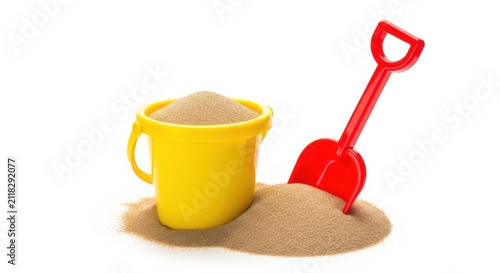 Yellow plastic bucket filled with sand and a red shovel isolated on white background
