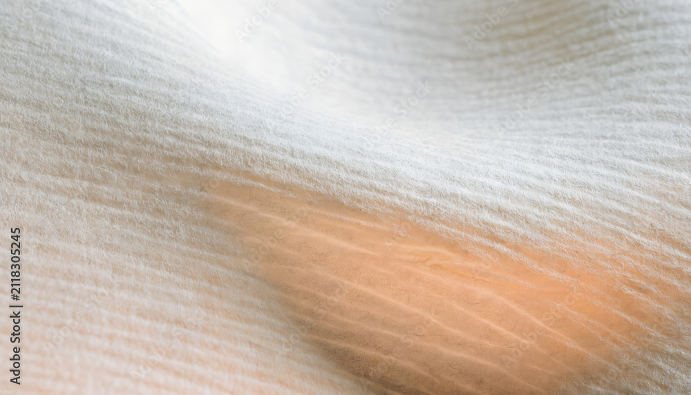 Fototapeta premium Soft White Cotton Fabric Texture Featuring Gentle Folds and Warm Sunlight Glow Abstract Background
