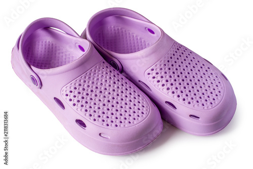 Pair of purple rubber clogs. Lightweight summer footwear for casual wear. Comfortable garden shoe for outdoor activity and leisure.