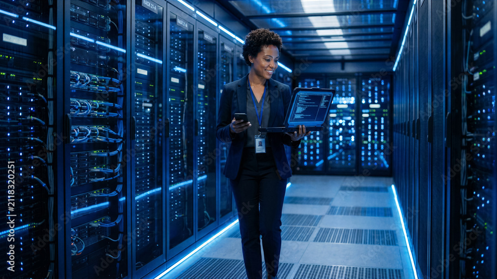 Fototapeta premium Confident cybersecurity expert walking through a modern high-tech server room with glowing blue LED lights
