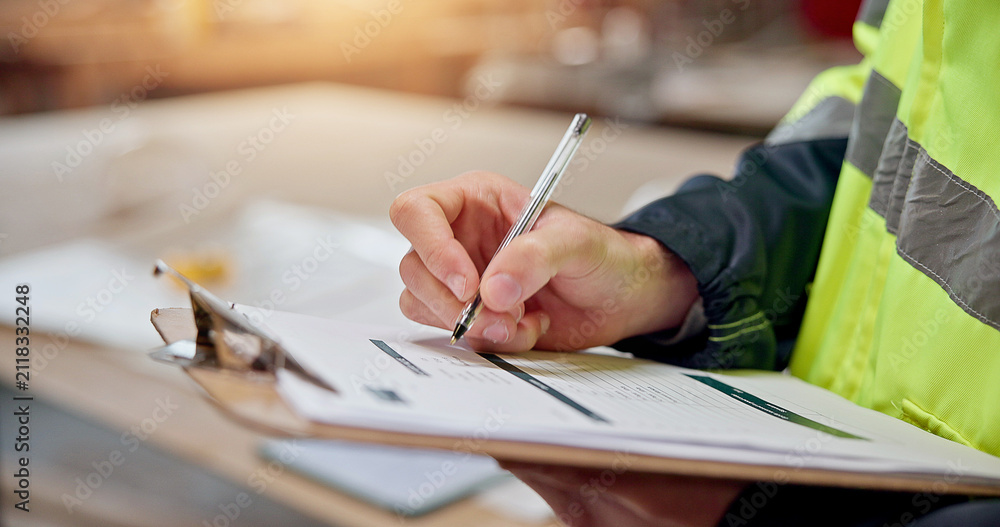 Fototapeta premium Clipboard, writing and engineer with hands in warehouse for furniture quote, stock review or planning. Manufacturing checklist, contractor invoice and evaluation with person in factory for project