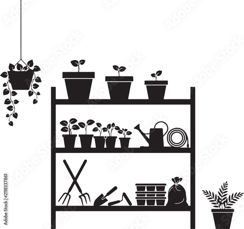 Interior of workshop with gardening tools, shelf unit and ladder