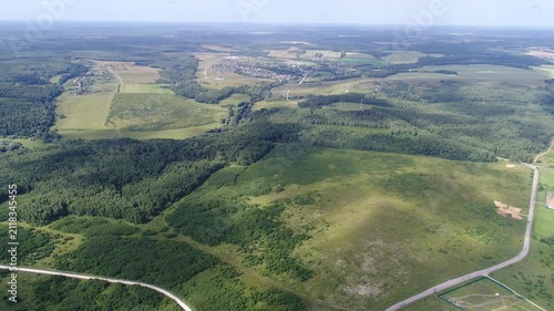 Smooth backward drone flight over rural landscape
