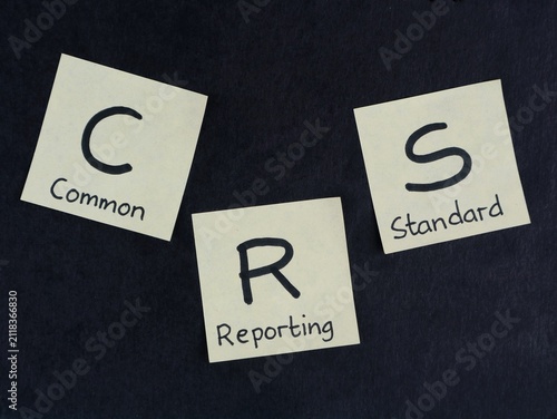 Canvastavla Commo Reporting and Standard (CRS) on yellow adhesive notes arranged on black background