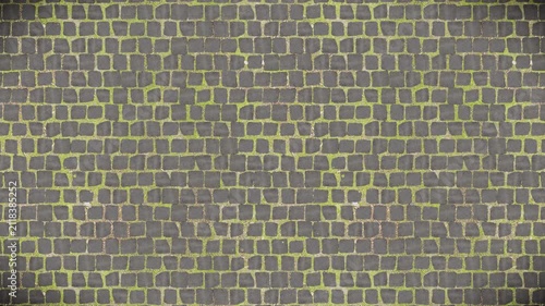 Weathered dark paving stones and bright green grass form a seamless loop.