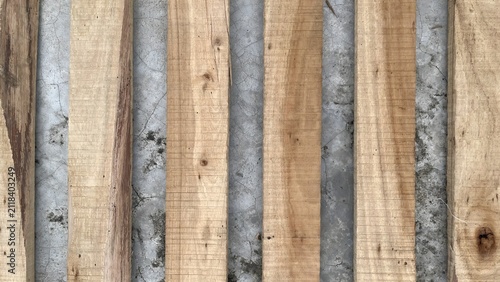 фотографія Top view of several parallel wooden planks arranged vertically on a textured gre
