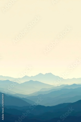 Soft dawn light bathes layered mountain ranges
