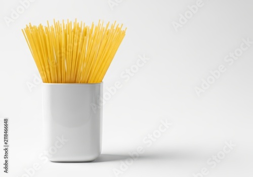 Uncooked Dry Spaghetti Pasta Noodles in a White Ceramic Container Isolated on White Background with Copy Space