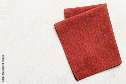 top view with red empty kitchen napkin isolated on table background. Folded cloth for mockup with copy space, Flat lay. Minimal style