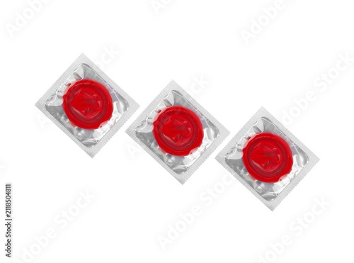 фотографія Three red prophylactic items in square foil blister containers.