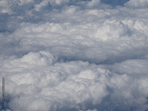 Obraz na płótnie Dense carpet of white clouds covering the earth surface seen from passenger airc
