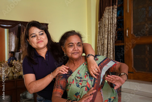 Daughter-in-law dancing in the living room with her mother-in-law at home 