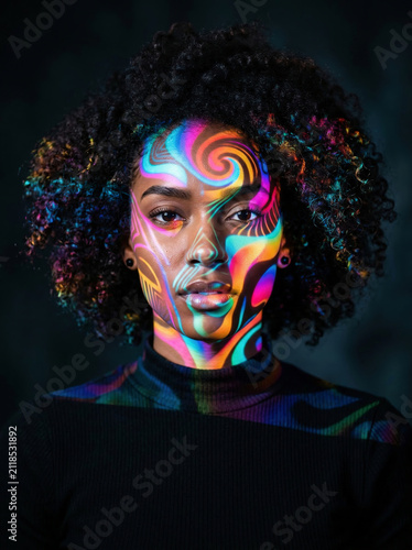 Vibrant portrait of a woman illuminated with colorful psychedelic projection mapping, blending contemporary art, digital creativity, and futuristic visual expression.