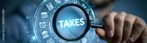 Taxation and Financial Scrutiny: A magnifying glass zeroes in on the word TAXES within a digital interface, symbolizing close examination of financial obligations and the intricacies of tax law.