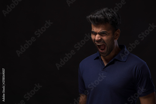 Portrait of a young man screaming 