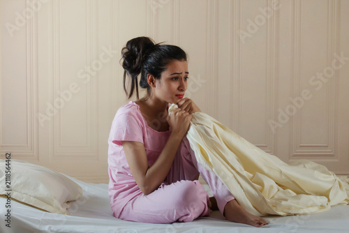 Young girl sitting alone in distress
