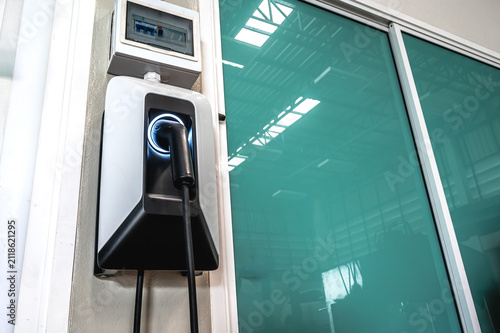 Modern EV wall box charging station installed on residential garage wall, providing convenient smart charging for electric car at home