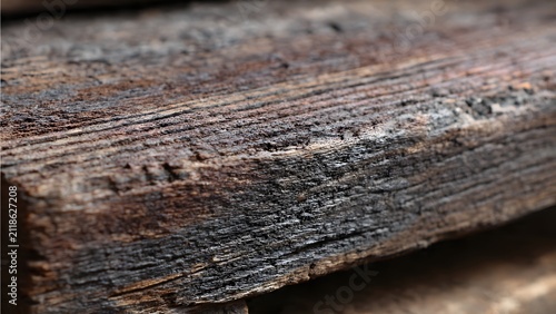Old durable timber texture featuring dark brown tones, rough grain, and natural weathering marks, 