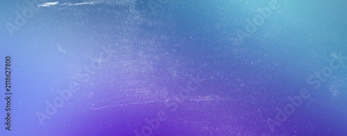 Vibrant purple and blue gradient background with heavy film grain texture and white dust scratches for artistic retro design projects and modern digital web banner applications today.