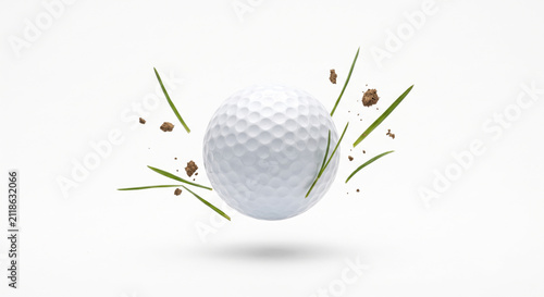 Golf ball with flying grass blades and soil divot isolated on white background, golf sport impact concept with copy space