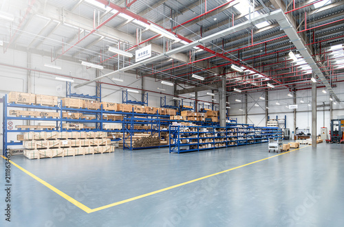 Fotografie Modern factory warehouse interior with storage racks and wooden crates