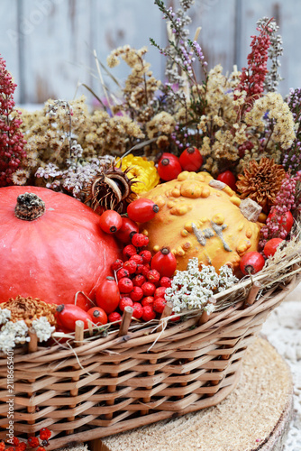 Autumn decoration with small pumpkins, heather, chestnuts and other autumn plants in a wicker basket. Step by step, tutorial.