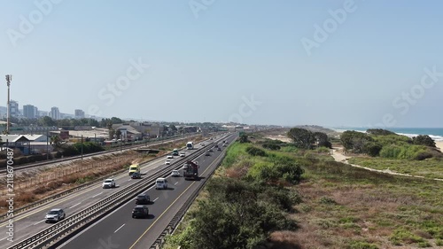 High-angle drone view of the southern exit of Haifa city near the coastline with traffic and urban scenery