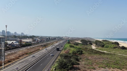 High-angle drone view of the southern exit of Haifa city near the coastline with traffic and urban scenery