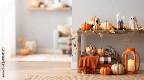 Decorative table with autumn pumpkins, ghost figure and lantern for Halloween celebration. Cosy living room interior with fall themed home decor items and warm string fairy light
