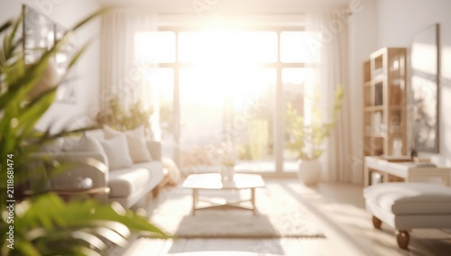 Soft-focus living room bathed in morning light from a large window, bright white tones for background use.
