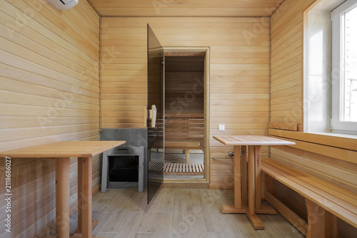 Wooden sauna interior with tables