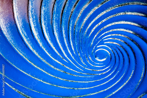 Фотография Blue glass spiral creating abstract whirlpool motion effect