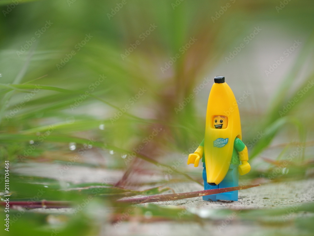 Fototapeta premium Indonesia - February 14, 2023 : Mini toy figure of banana character at outdoor with blurred background. Toy photography concept design.