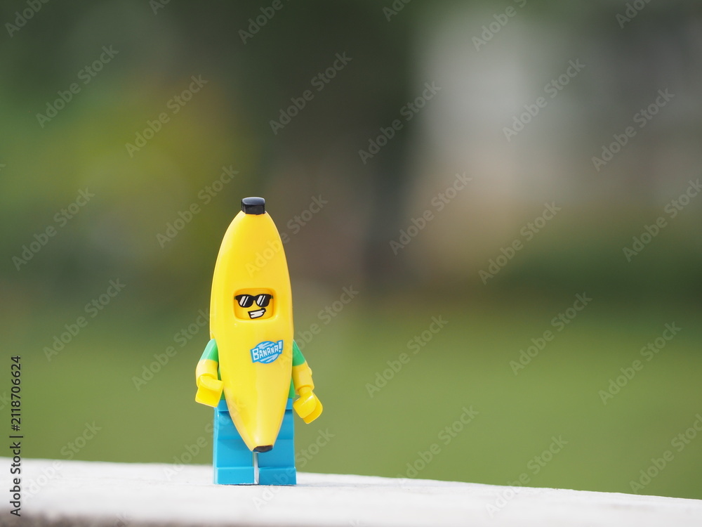 Fototapeta premium Indonesia - December 8, 2018 : Mini toy of action figure at outdoor with blurred background. Toy photography concept design. Banana guy character at garden.