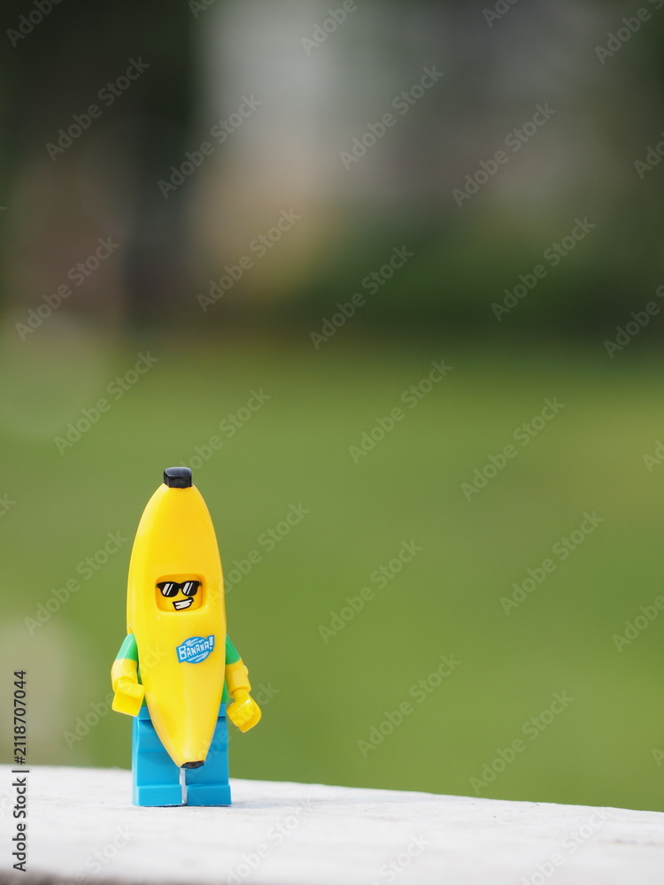 Fototapeta premium Indonesia - December 8, 2018 : Mini toy of action figure at outdoor with blurred background. Toy photography concept design. Banana guy character at garden.