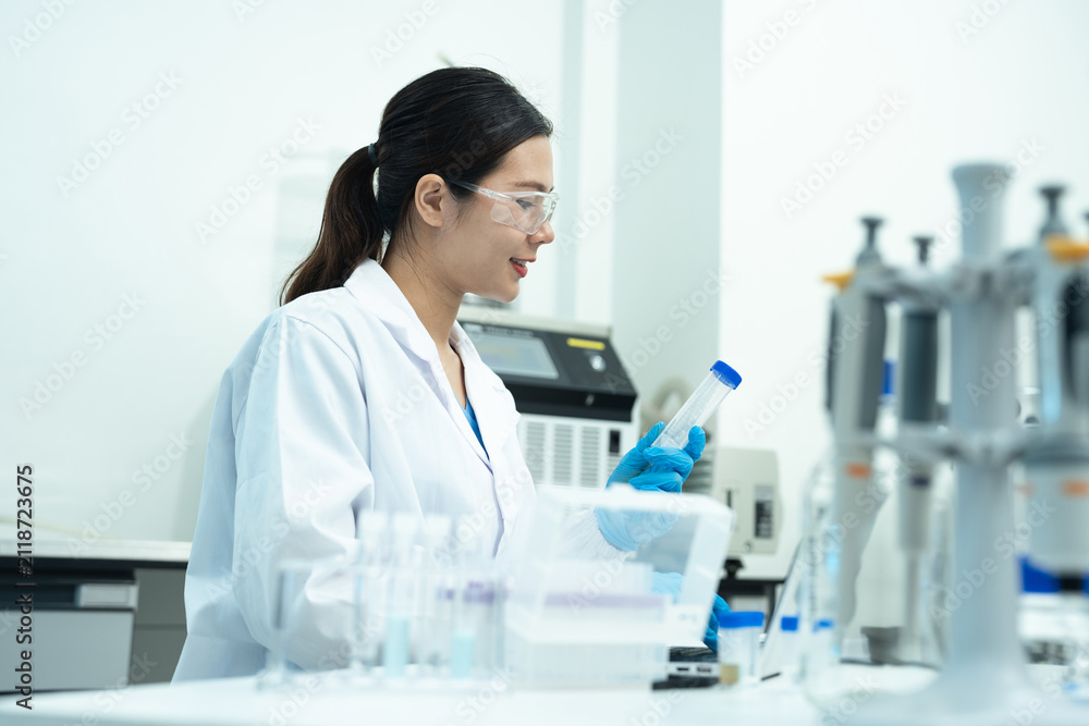 Fototapeta premium Lab work, scientists holds a test tube takes the test from a test tube in analysis for vaccine development.