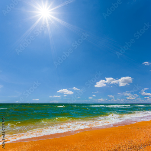summer sandy sea beach under a blue cloudy sky at the sunny day
